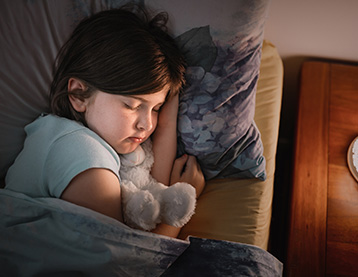 Girl sleeping with her teddy